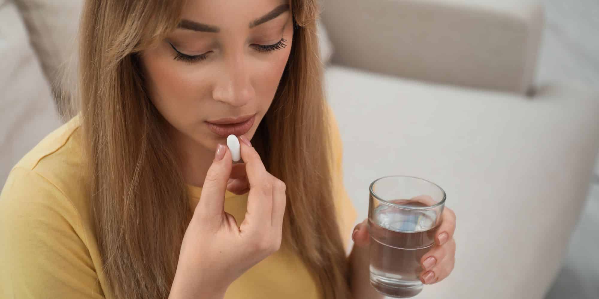 woman taking a pill